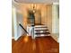 Hallway view of staircase featuring wood steps, white risers, and a brick wall at 3713 Saint Regis Dr, Gastonia, NC 28056