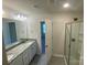 Bathroom with double sink vanity, granite countertops and glass shower, blending functionality with style at 3776 Yorkshire Pl, Terrell, NC 28682