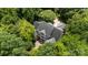 Stunning aerial view of a secluded estate home surrounded by lush greenery and mature trees at 3819 Gleneagles Rd, Charlotte, NC 28210