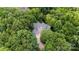 Aerial view of a wooded property featuring a large home with a long driveway at 3819 Gleneagles Rd, Charlotte, NC 28210