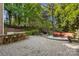Spacious backyard featuring outdoor kitchen, dining, firepit and lounge area at 3819 Gleneagles Rd, Charlotte, NC 28210