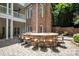 Backyard patio featuring an outdoor kitchen with a stone fire pit and bar seating at 3819 Gleneagles Rd, Charlotte, NC 28210