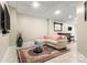 Cozy finished basement featuring a sofa, coffee table, TV, and a wet bar at 3819 Gleneagles Rd, Charlotte, NC 28210