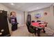 Finished basement with a game room, complete with vintage slot machines and a poker table at 3819 Gleneagles Rd, Charlotte, NC 28210