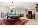 Finished basement with a pool table, wet bar, tile floors, and a red rug at 3819 Gleneagles Rd, Charlotte, NC 28210