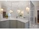 Stylish bathroom featuring a vanity with a marble countertop, and modern light fixtures providing a spa-like feel at 3819 Gleneagles Rd, Charlotte, NC 28210