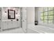Bright bathroom featuring white cabinets, a glass enclosed shower, and a tub at 3819 Gleneagles Rd, Charlotte, NC 28210