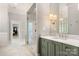 This bathroom offers a frameless glass enclosed shower, a designer vanity with marble countertops, and decorative lighting at 3819 Gleneagles Rd, Charlotte, NC 28210