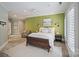 Inviting bedroom with a textured wall, cozy seating, and ample natural light, creating a relaxing atmosphere at 3819 Gleneagles Rd, Charlotte, NC 28210