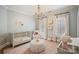 Charming Bedroom featuring a soft color palette, chandelier, and natural light at 3819 Gleneagles Rd, Charlotte, NC 28210
