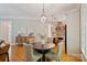 Dining area with hardwood floors, elegant lighting, and seamless access to the kitchen at 3819 Gleneagles Rd, Charlotte, NC 28210