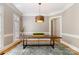 Formal dining room featuring hardwood floors, elegant lighting, and neutral paint at 3819 Gleneagles Rd, Charlotte, NC 28210