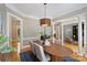 Elegant dining room with an oval table, stylish chairs, and sophisticated lighting fixture creating an inviting ambiance at 3819 Gleneagles Rd, Charlotte, NC 28210