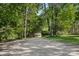 Long driveway leading to a private estate, surrounded by mature trees and lush landscaping at 3819 Gleneagles Rd, Charlotte, NC 28210