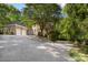 Brick exterior home with a circular driveway and multiple garage spaces surrounded by trees at 3819 Gleneagles Rd, Charlotte, NC 28210