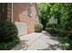Brick home exterior with a basketball hoop and a three car garage at 3819 Gleneagles Rd, Charlotte, NC 28210
