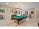 Entertaining game room with a pool table, fireplace, and cozy seating area near the window at 3819 Gleneagles Rd, Charlotte, NC 28210