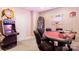 Finished basement game room featuring various arcade games, a card table, and neon signs at 3819 Gleneagles Rd, Charlotte, NC 28210