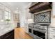 Gourmet kitchen features an oversized stainless range, custom cabinets, stone countertops, and designer backsplash at 3819 Gleneagles Rd, Charlotte, NC 28210