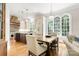 Bright kitchen features a large island, wooden table, and an abundance of natural light from the arched windows at 3819 Gleneagles Rd, Charlotte, NC 28210