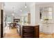 Gourmet kitchen features a center island with stone countertops that is open to a breakfast nook and the living room at 3819 Gleneagles Rd, Charlotte, NC 28210