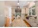 Spacious kitchen with a large island, custom cabinetry, stone hood, and natural light at 3819 Gleneagles Rd, Charlotte, NC 28210
