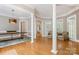 Open-concept living room featuring hardwood floors, natural light, and neutral paint at 3819 Gleneagles Rd, Charlotte, NC 28210
