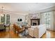 Bright living room featuring a stone fireplace, hardwood floors, and stylish furniture at 3819 Gleneagles Rd, Charlotte, NC 28210