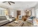 Open living room with a view into the kitchen, featuring hardwood floors and comfortable seating at 3819 Gleneagles Rd, Charlotte, NC 28210