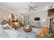Open-concept living room boasts hardwood floors, a fireplace, and seamless access to the kitchen at 3819 Gleneagles Rd, Charlotte, NC 28210