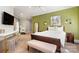 Bedroom with an olive green accent wall, a bed, and an art piece at 3819 Gleneagles Rd, Charlotte, NC 28210