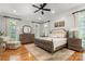 This spacious main bedroom features hardwood floors, decorative windows, and luxurious furnishings at 3819 Gleneagles Rd, Charlotte, NC 28210