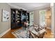 Stylish office space with a built-in bookcase, hardwood floors, and plenty of natural light at 3819 Gleneagles Rd, Charlotte, NC 28210