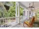 Inviting porch with swing, rocking chair and peaceful views of backyard at 3819 Gleneagles Rd, Charlotte, NC 28210