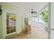 Covered porch with rocking chairs, offering a relaxing outdoor space with views of the surrounding landscape at 3819 Gleneagles Rd, Charlotte, NC 28210