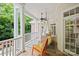 Spacious porch with a swing and rocking chair, perfect for enjoying the outdoors at 3819 Gleneagles Rd, Charlotte, NC 28210