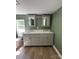 Bathroom boasts a double sink vanity with gray cabinets, and modern mirrors at 427 W Whitley St, Norwood, NC 28128