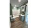 Cozy bathroom featuring a stand-up shower, modern sink, and wood-look flooring at 427 W Whitley St, Norwood, NC 28128
