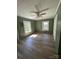 Comfortable bedroom with wood-look flooring, a ceiling fan, and natural light at 427 W Whitley St, Norwood, NC 28128