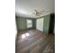 Bedroom features wood floors, ceiling fan, and neutral green wall color at 427 W Whitley St, Norwood, NC 28128