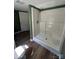 Walk-in shower with a built-in seat, white tile surround, and chrome shower head at 427 W Whitley St, Norwood, NC 28128