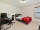 This is a cozy bedroom with a neutral color scheme and lots of natural light at 4606 Gatesmills Ave, Charlotte, NC 28213