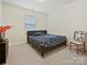 Simple bedroom with a bed, carpeted floors, and a window providing natural light at 4606 Gatesmills Ave, Charlotte, NC 28213