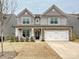 Charming two-story home featuring a two-car garage, stone accents, and a well-maintained lawn at 4606 Gatesmills Ave, Charlotte, NC 28213