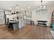 Bright kitchen featuring stainless steel appliances, quartz countertops, stylish pendant lighting, and a kitchen island at 4606 Gatesmills Ave, Charlotte, NC 28213