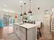 Open concept kitchen with an island, stainless steel appliances, and seamless flow into the living area at 4606 Gatesmills Ave, Charlotte, NC 28213