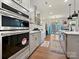 Modern kitchen with stainless steel appliances, light countertops, and a view of the outdoor space at 4606 Gatesmills Ave, Charlotte, NC 28213