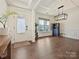 Elegant living room with hardwood floors, coffered ceilings, and ample natural light from large windows at 4606 Gatesmills Ave, Charlotte, NC 28213