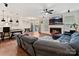 Open-concept living area featuring a fireplace, ceiling fan, and access to the kitchen and outdoor spaces at 4606 Gatesmills Ave, Charlotte, NC 28213