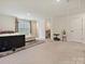 Spacious living room with carpet, ample natural light, and a comfortable seating area at 4606 Gatesmills Ave, Charlotte, NC 28213